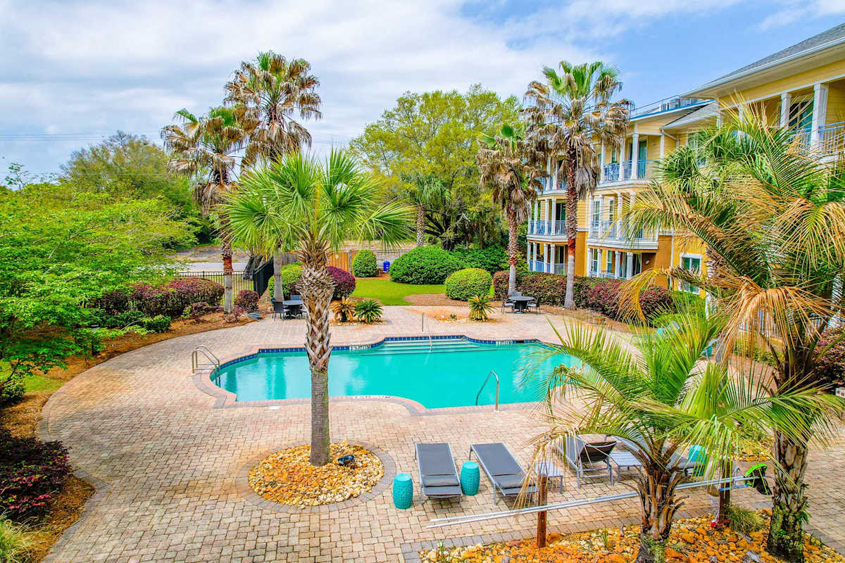 The Altair Senior Apartment Living pool with palm trees - Pensacola, FL