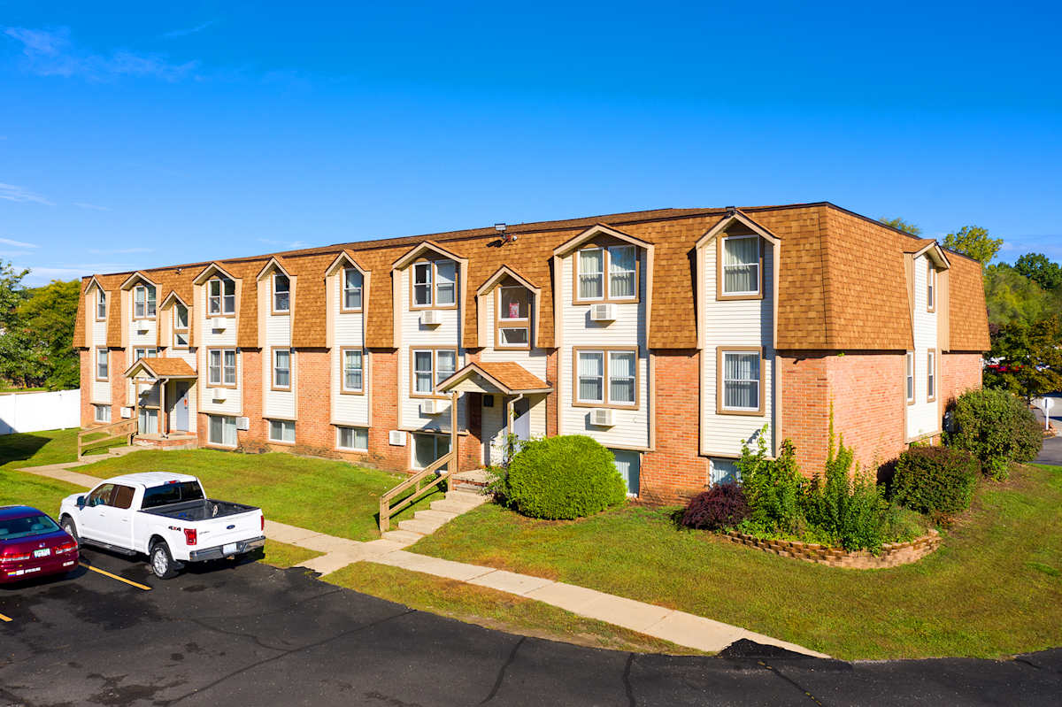 Arbor One Apartments exterior brick building with parking - Ypsilanti, MI