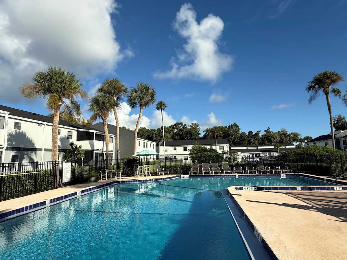 The Artisan Apartments pool with palm trees - Daytona, FL