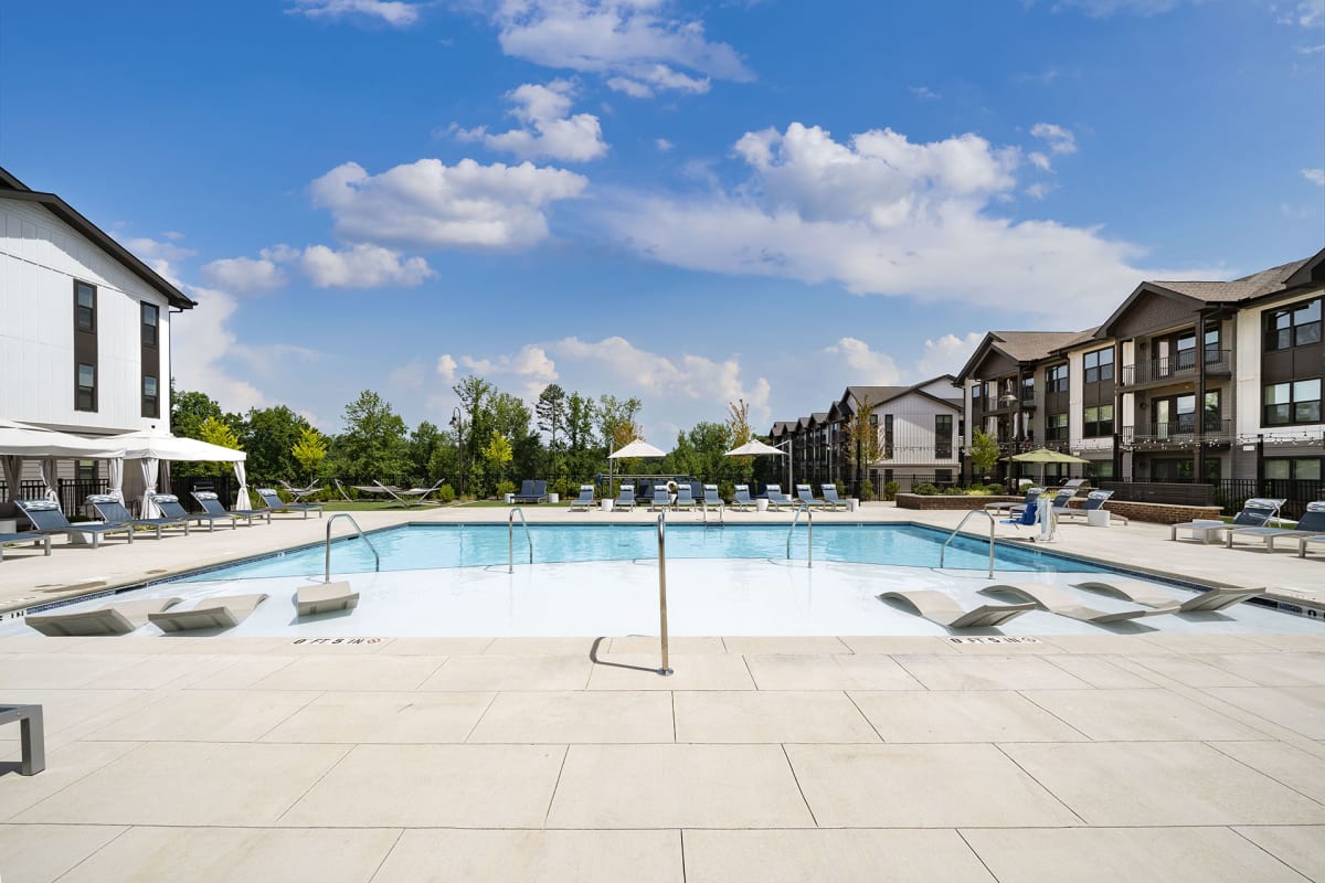 The Banks at Mt. Holly Apartments pool with sunning platform and lounge chairs - Belmont, NC