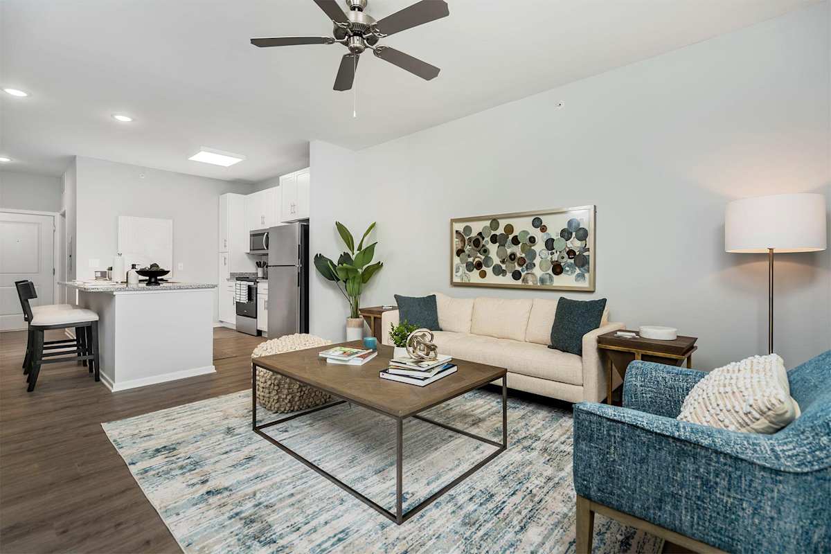 The Retreat Apartments living room with ceiling fan - Wyoming, MI