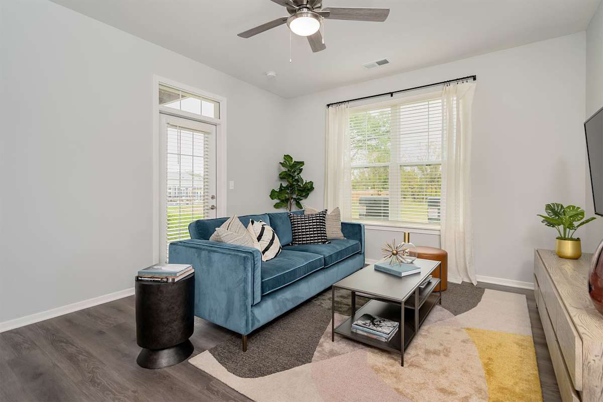 The Retreat Apartments living room with wood-style flooring - Wyoming, MI