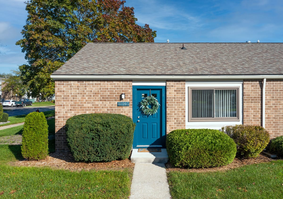Waters Landing Apartments brick building exterior with blue door - Saginaw, MI