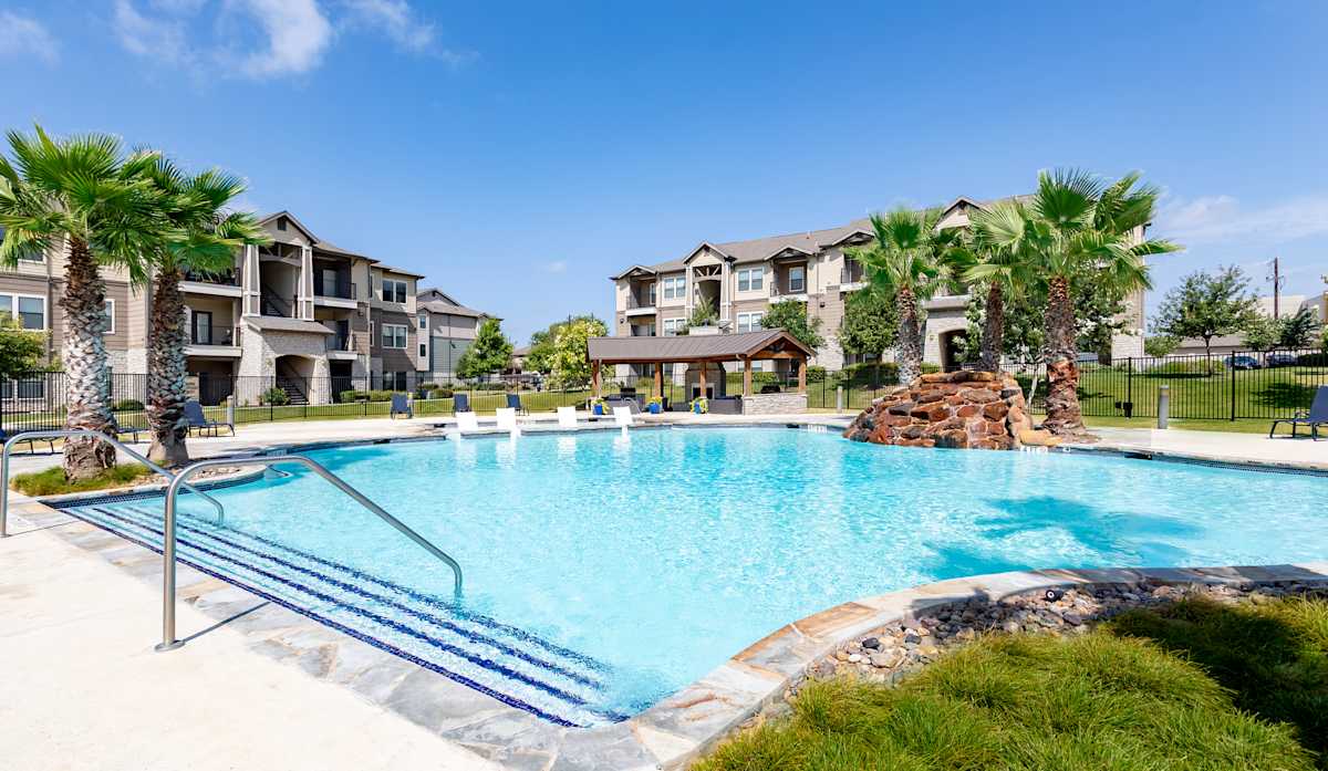 Verandas at Alamo Ranch resort-style pool and apartment building - San Antonio, TX