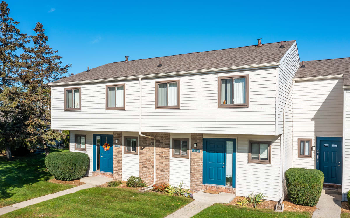 Waters Landing Apartments exterior building with blue doors and windows - Saginaw, MI