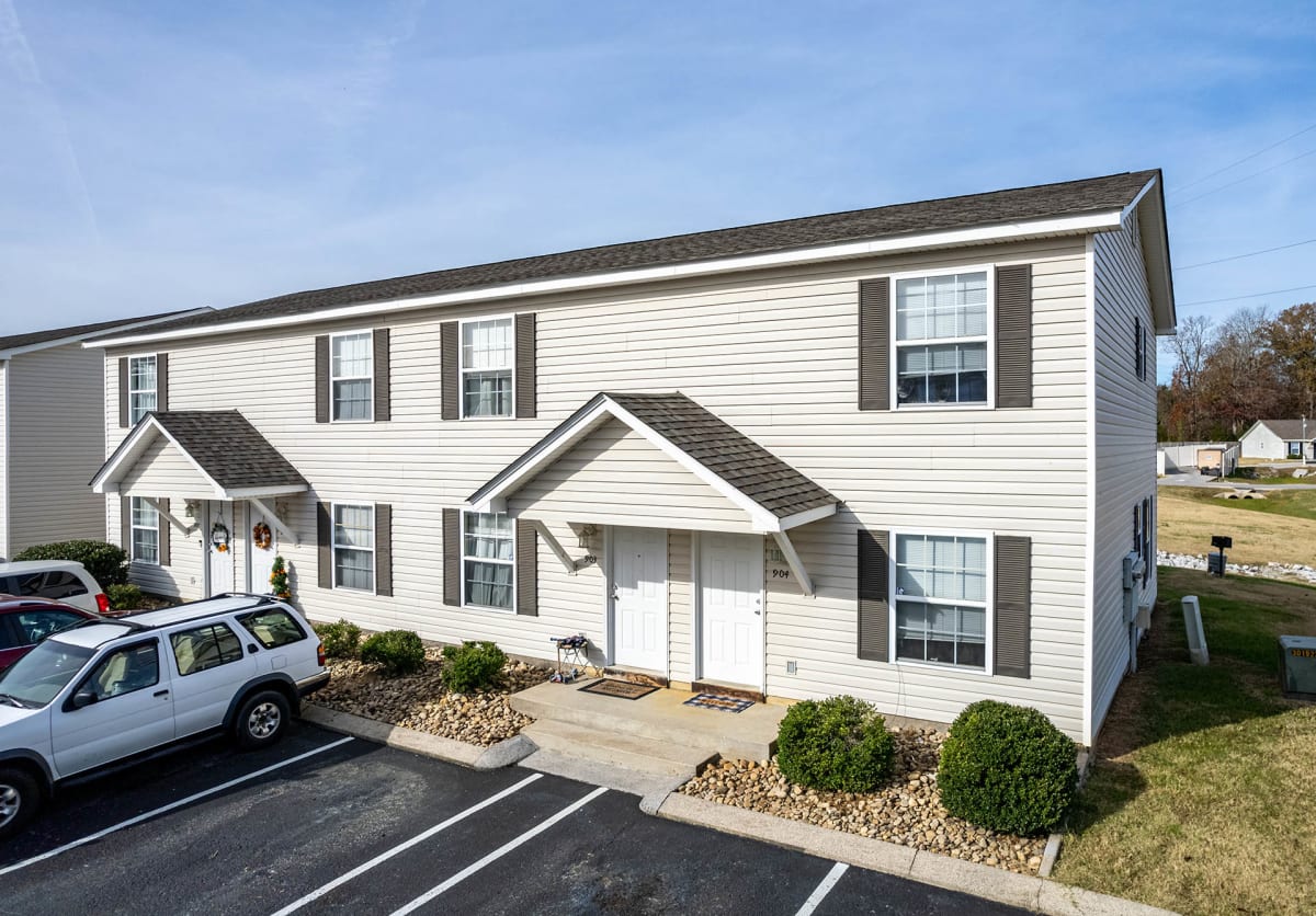The Villages at Fort Town Apartments exterior with parking lot - Fort Oglethorpe, GA