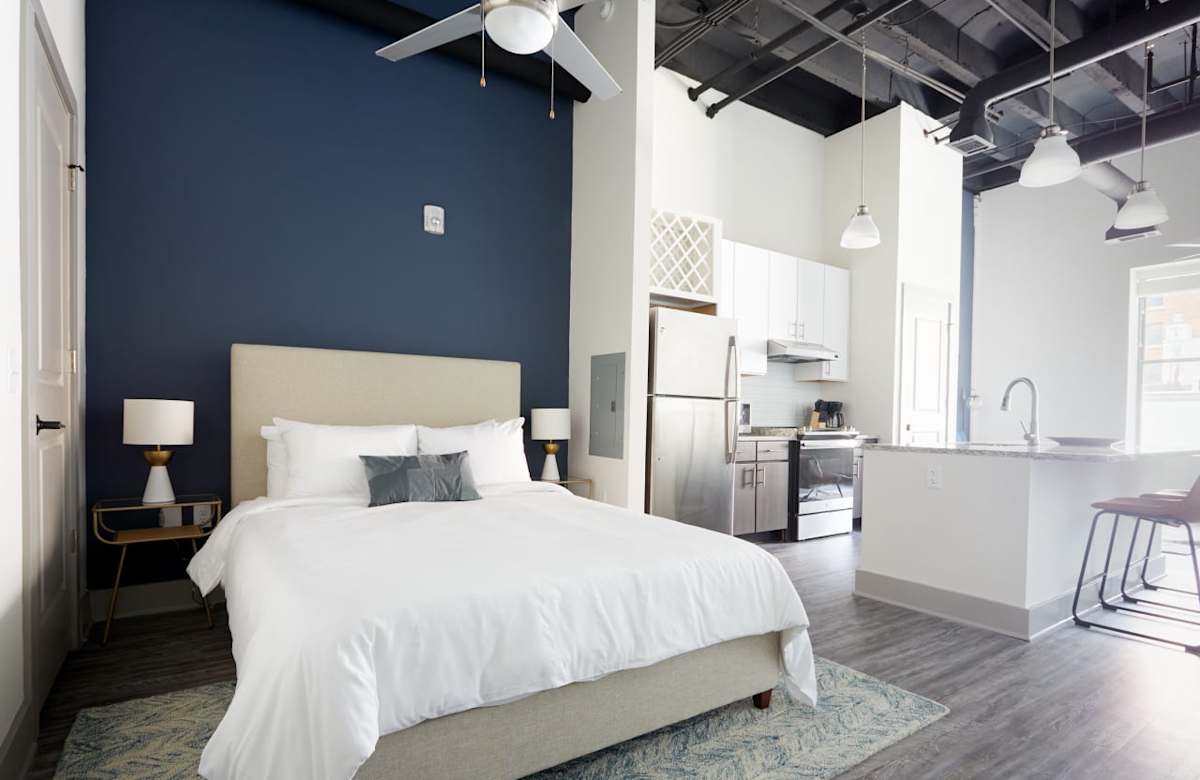 Capital Bull Apartments studio bedroom and kitchenette - Savannah, GA