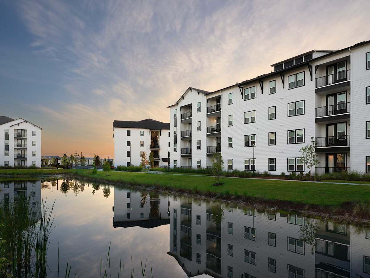 The Kelly at 23rd Luxury Apartments exterior reflected on lake - Panama City, FL