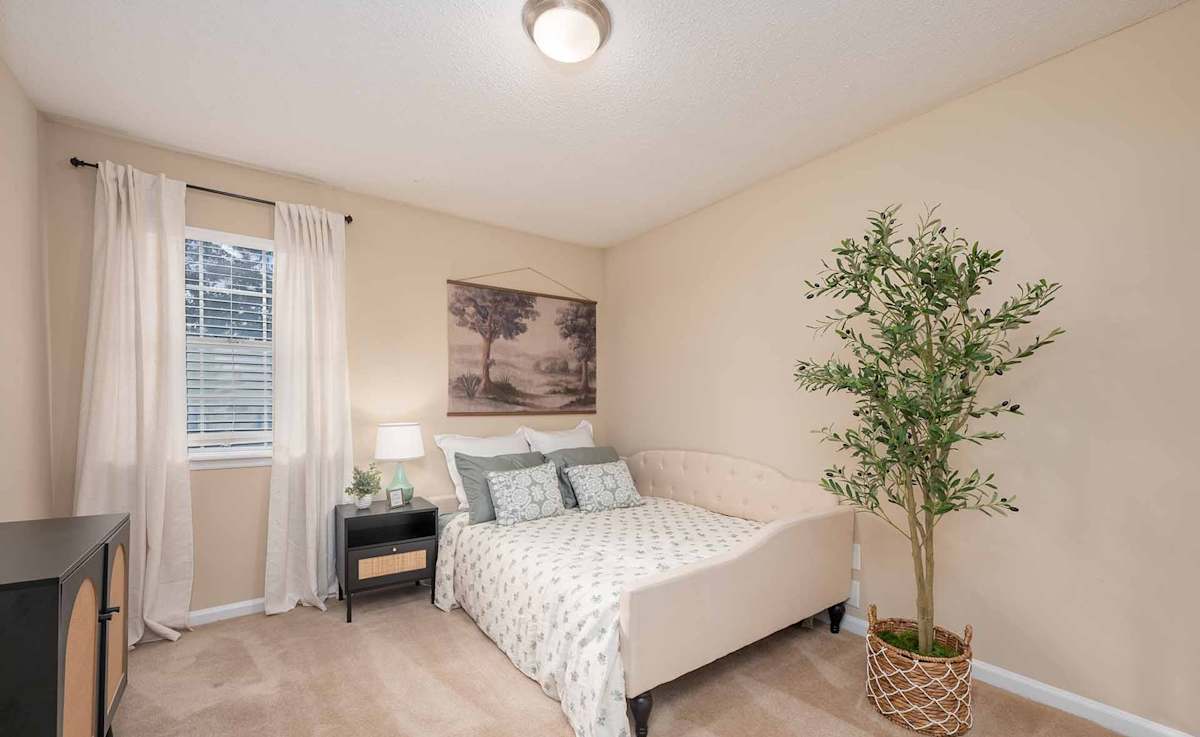 Georgia Green Townhome Apartments bedroom with nightstand - Athens, GA