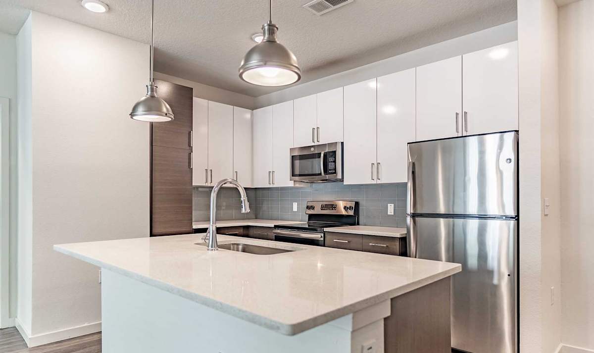 Havana Square Apartments kitchen with island and stainless appliances - Tampa, FL