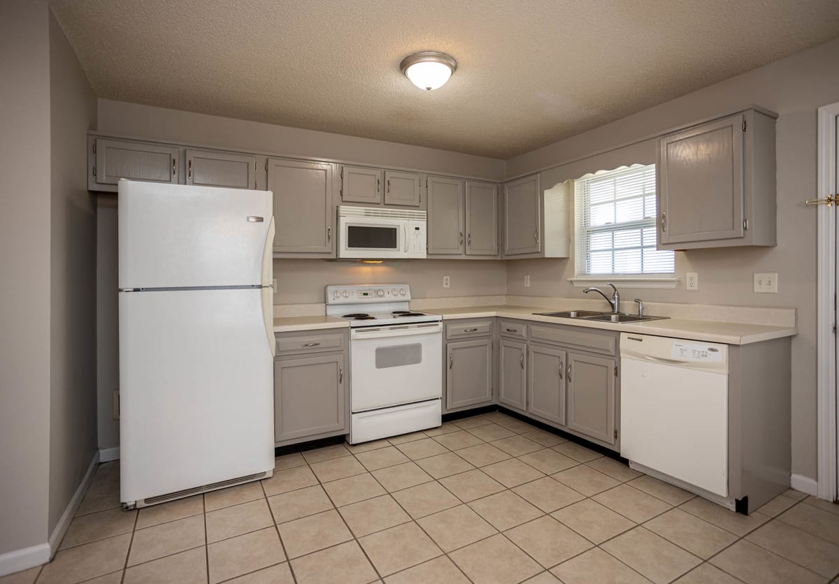 The Villages at Fort Town Apartments kitchen with gray cabinets - Fort Oglethorpe, GA