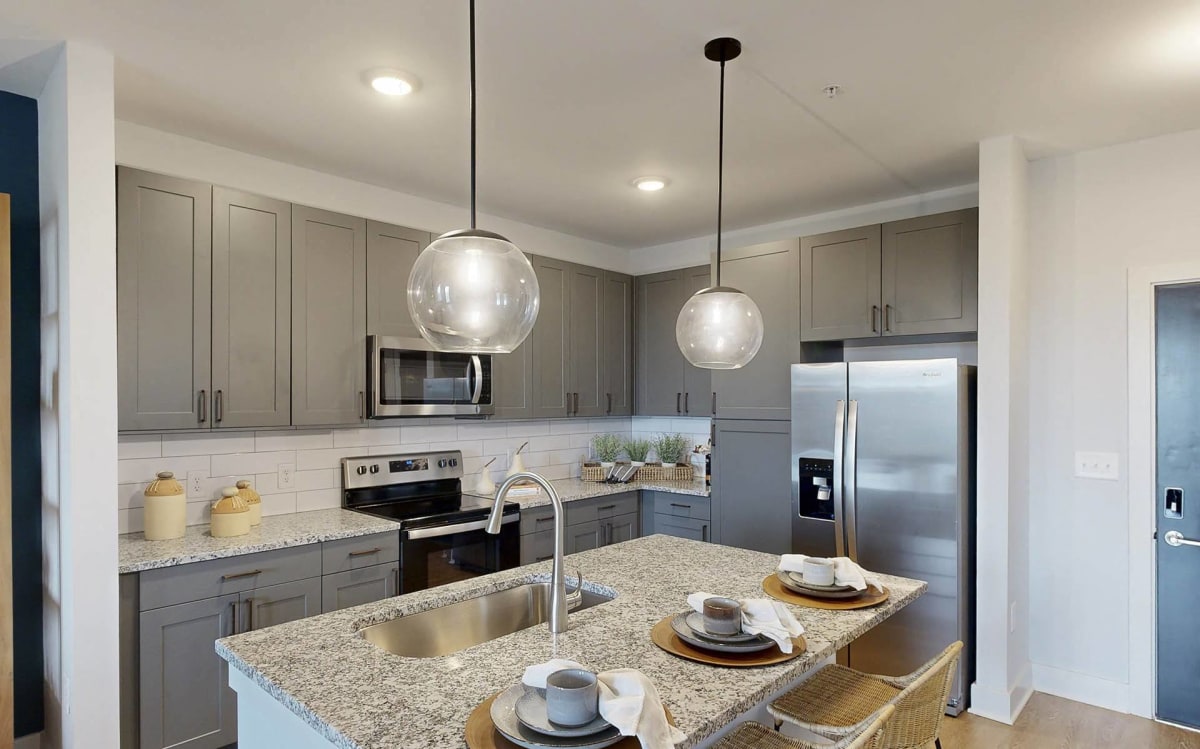 The Dempsey Apartments unit kitchen with island - Madison, AL