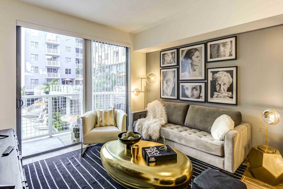 Lazul North Miami Beach Apartments living room with balcony access - North Miami Beach, FL