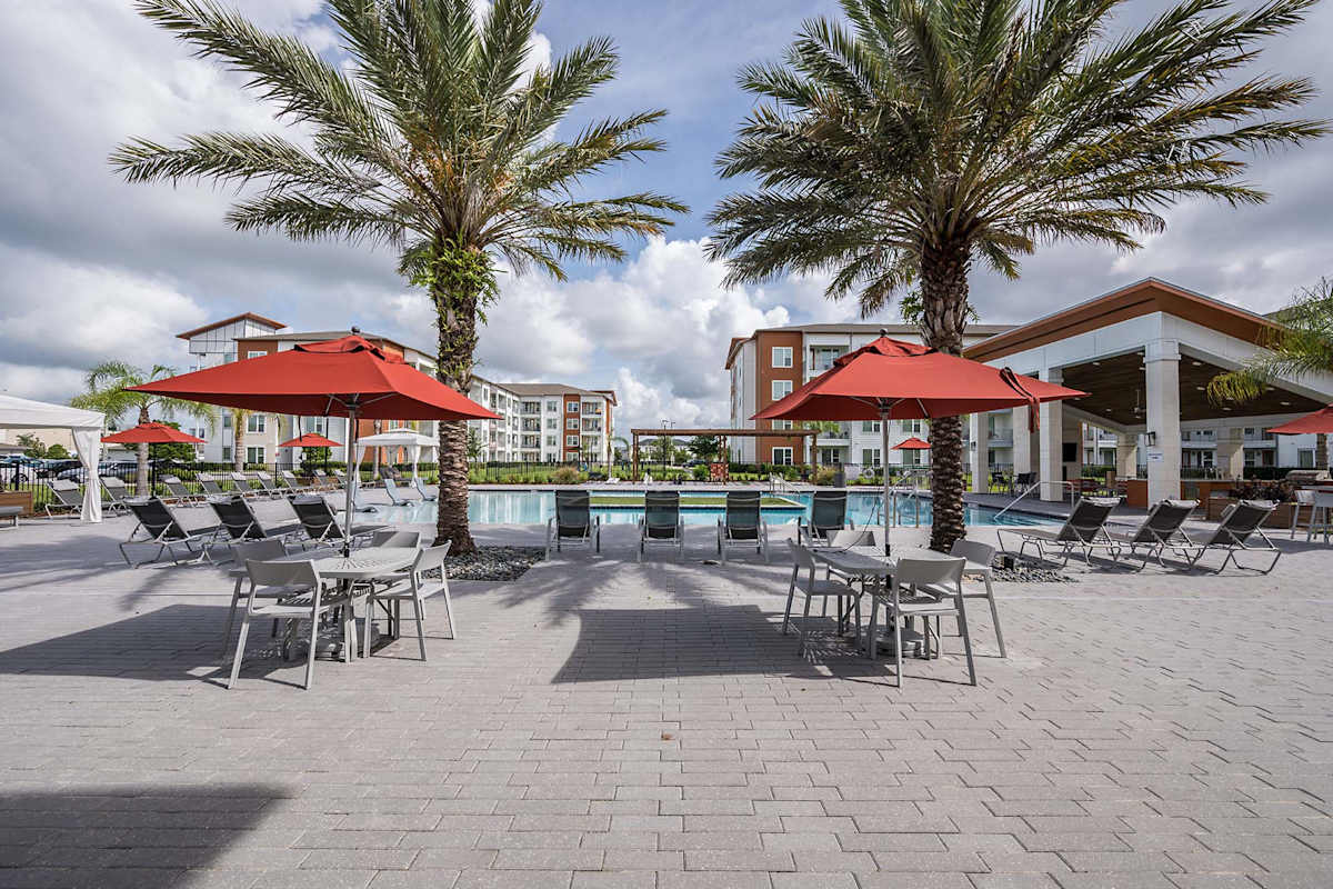 Madison Pointe Apartments pool deck with umbrellas - Daytona Beach, FL