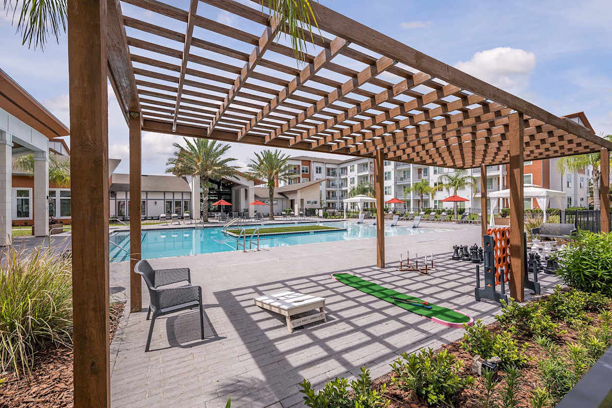 Madison Pointe Apartments poolside pergola seating - Daytona Beach, FL