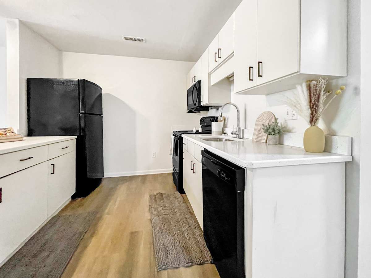 The Mill Apartments modern kitchen with white cabinetry - Harrisonburg, VA