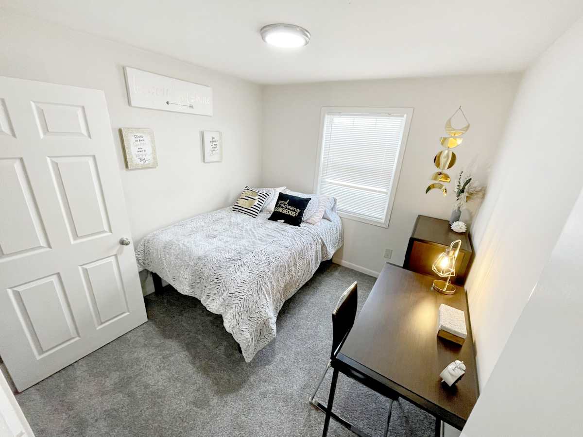 The Mill Apartments bright furnished bedroom with window - Harrisonburg, VA
