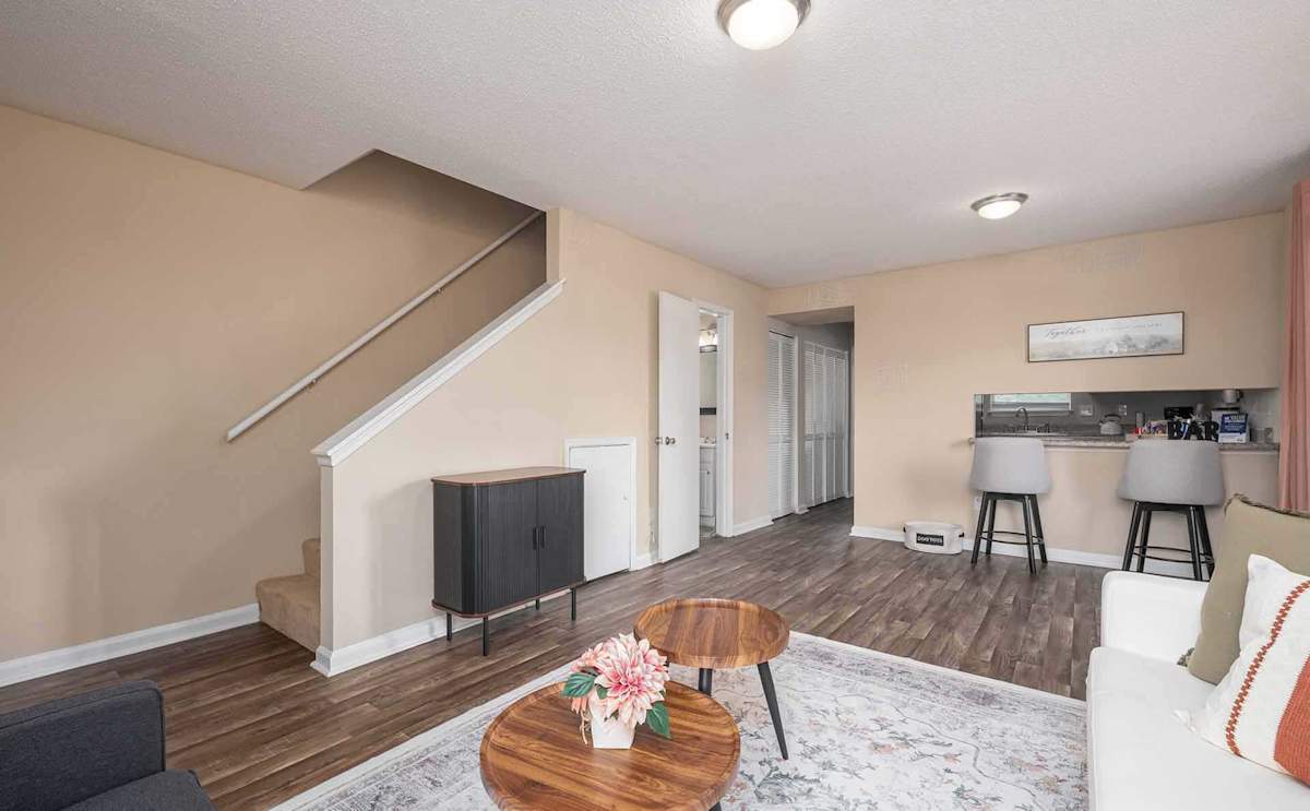 Georgia Green Townhome Apartments living room with stairs - Athens, GA