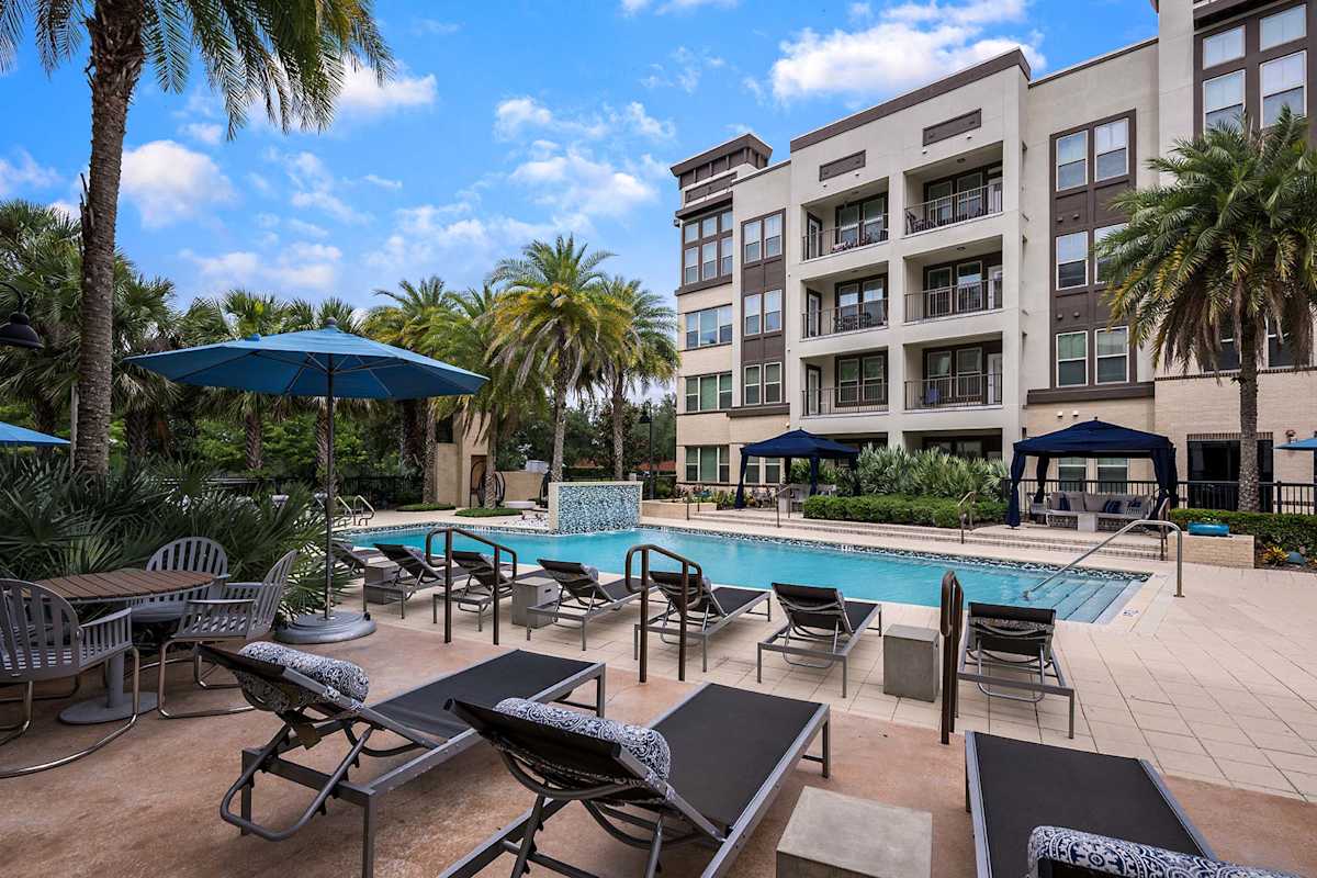 Nine12 Gateway Apartments swimming pool deck with lounge chairs - Altamonte Springs, FL