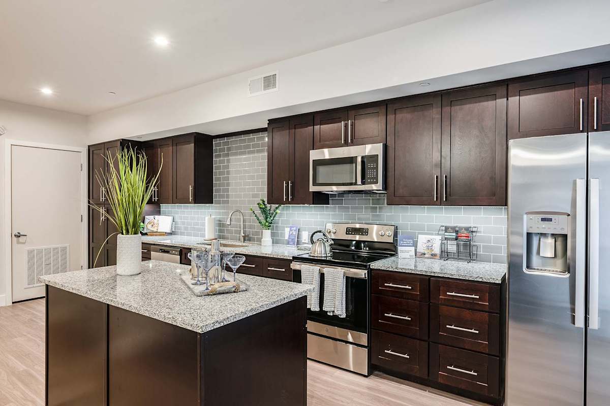 Nine12 Gateway Apartments unit kitchen with stainless steel appliances - Altamonte Springs, FL