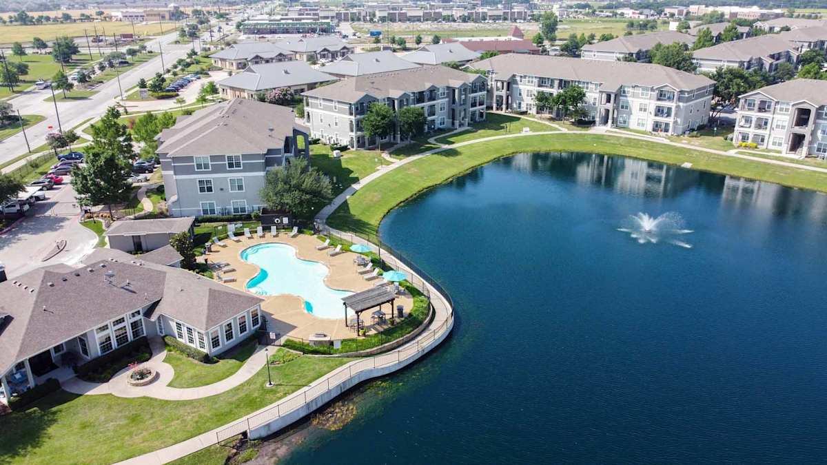 Orion Prosper Apartments aerial view with pool and pond - Prosper, TX