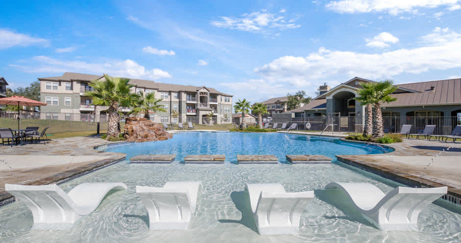 Verandas at Alamo Ranch pool seating and lounge chairs - San Antonio, TX
