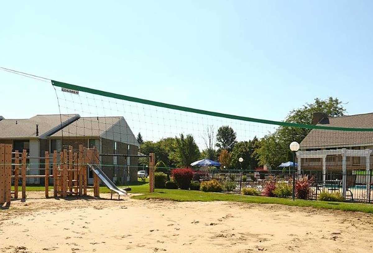 Waters Landing Apartments sand volleyball court and playground - Saginaw, MI
