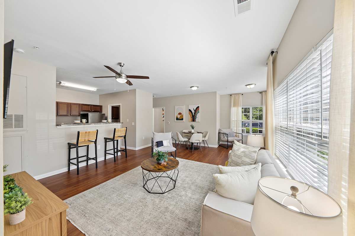 Vintage Retreat Apartments living room with sofa and ceiling fan - Cleveland, TN