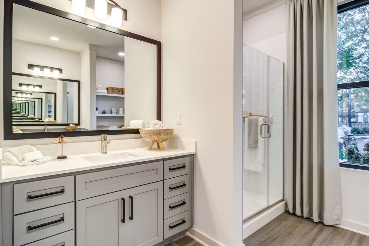 The Collins Luxury Apartments bathroom with glass shower - Huntsville, AL