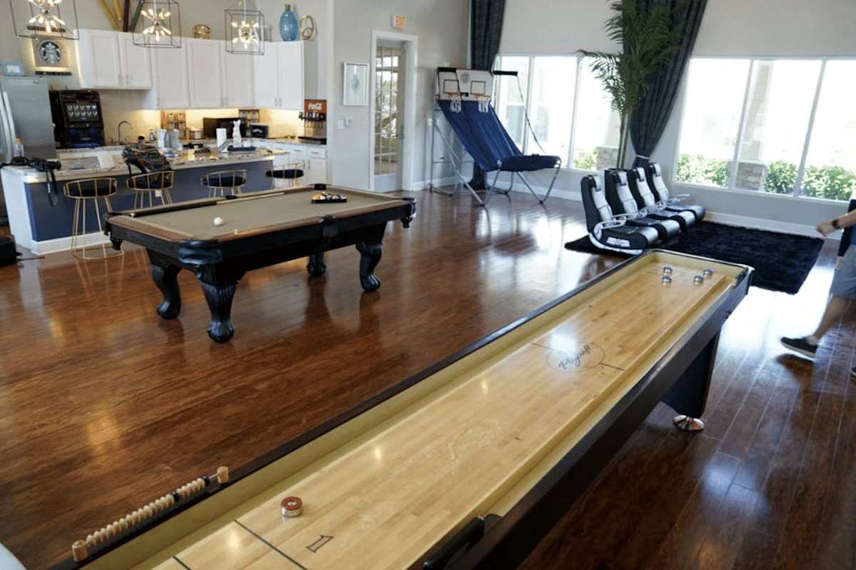 The Cove Apartments game room with tables - Ingleside, TX