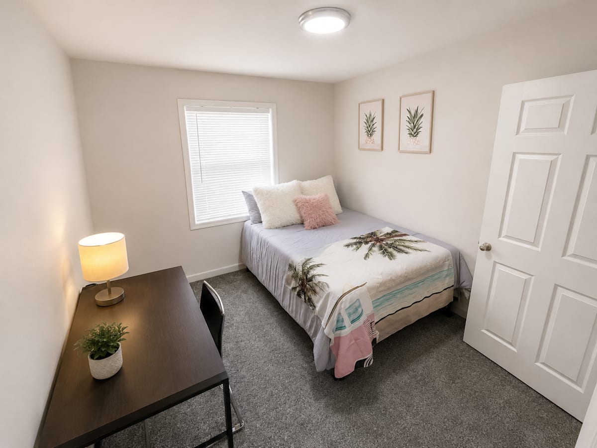 The Mill Apartments furnished bedroom with nightstand - Harrisonburg, VA