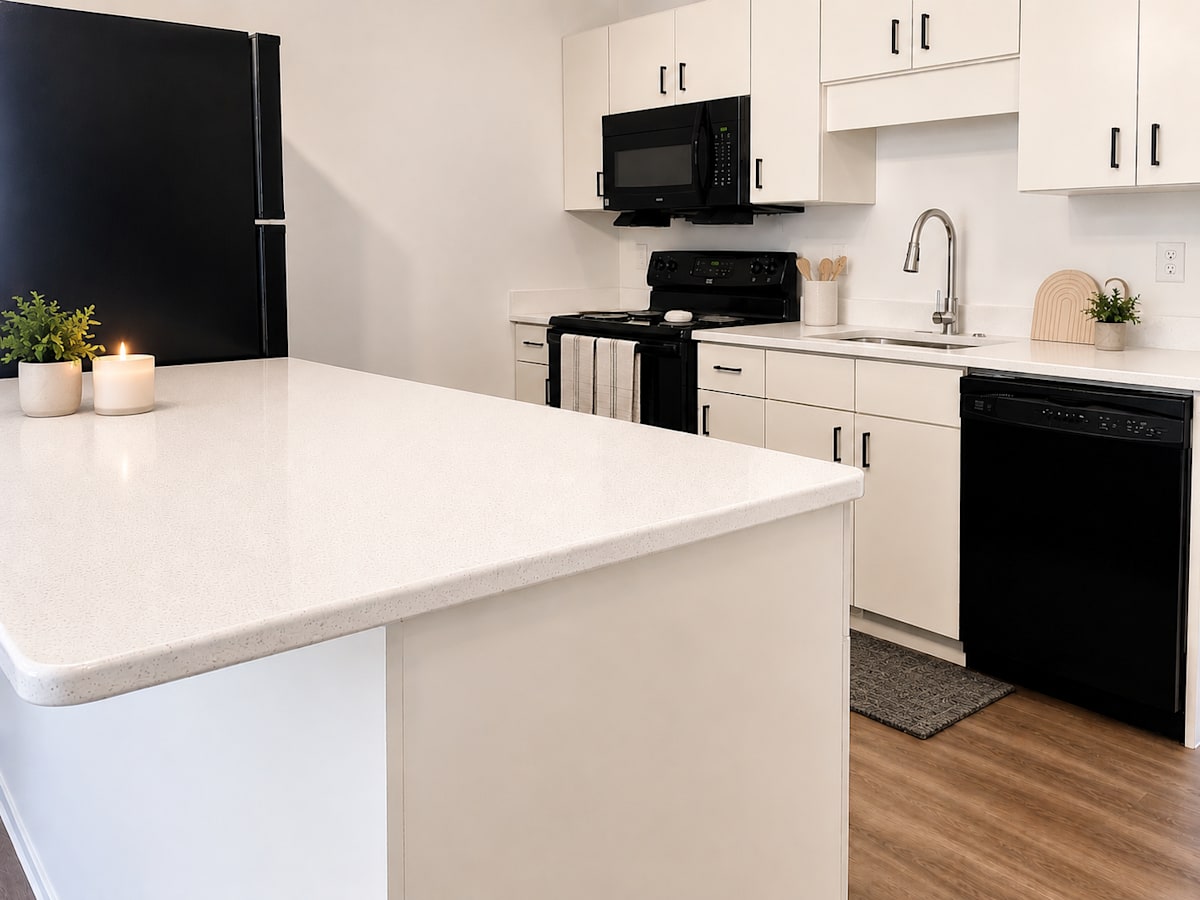 The Mill Apartments kitchen with black appliances - Harrisonburg, VA