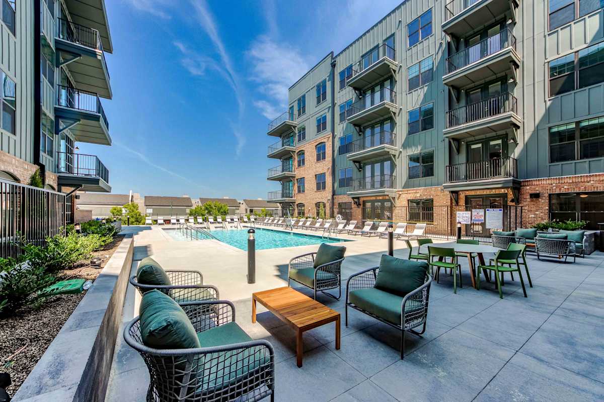 The Oliver Luxury Apartments pool with lounge seating - Memphis, TN