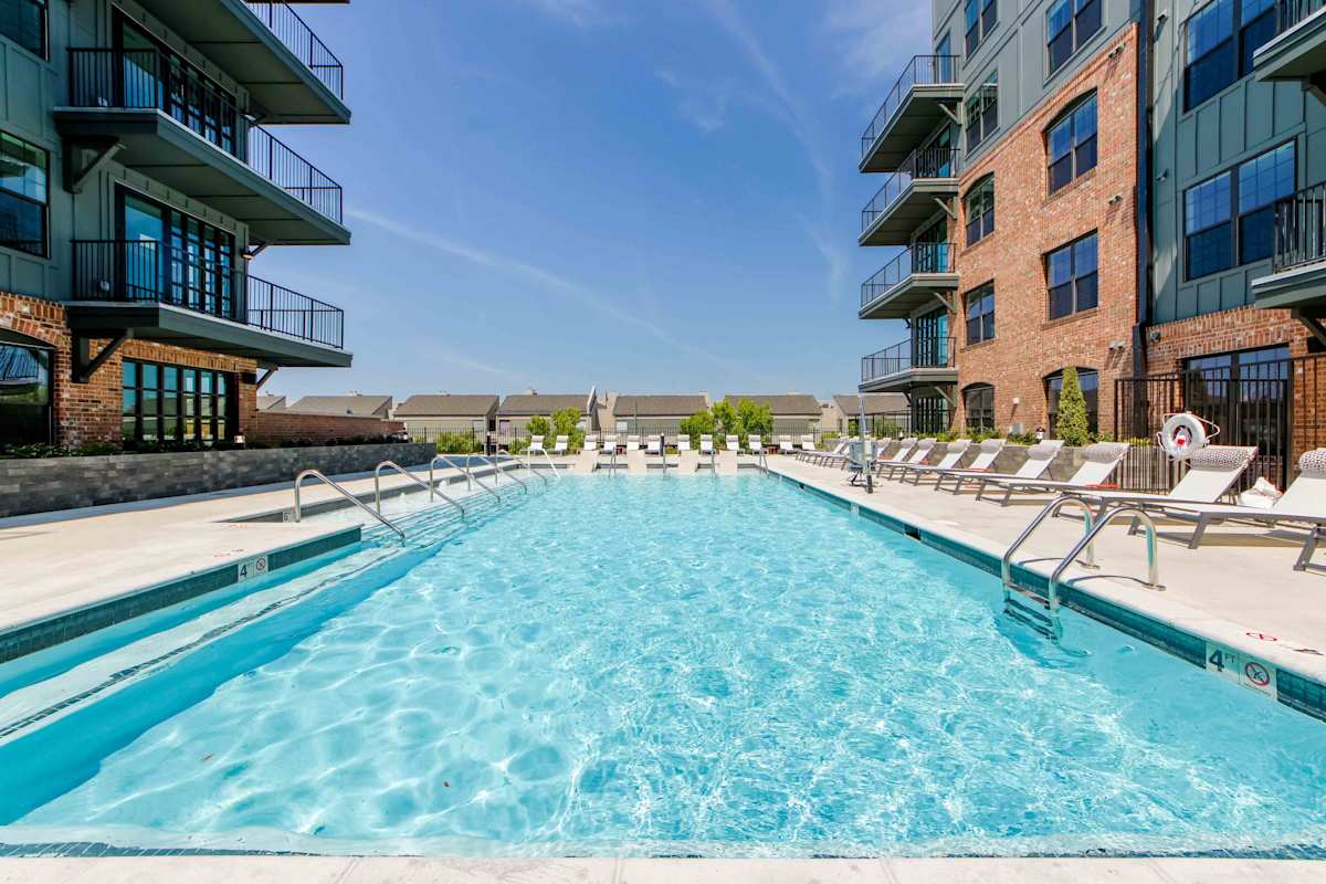 The Oliver Luxury Apartments pool deck with lounge chairs - Memphis, TN