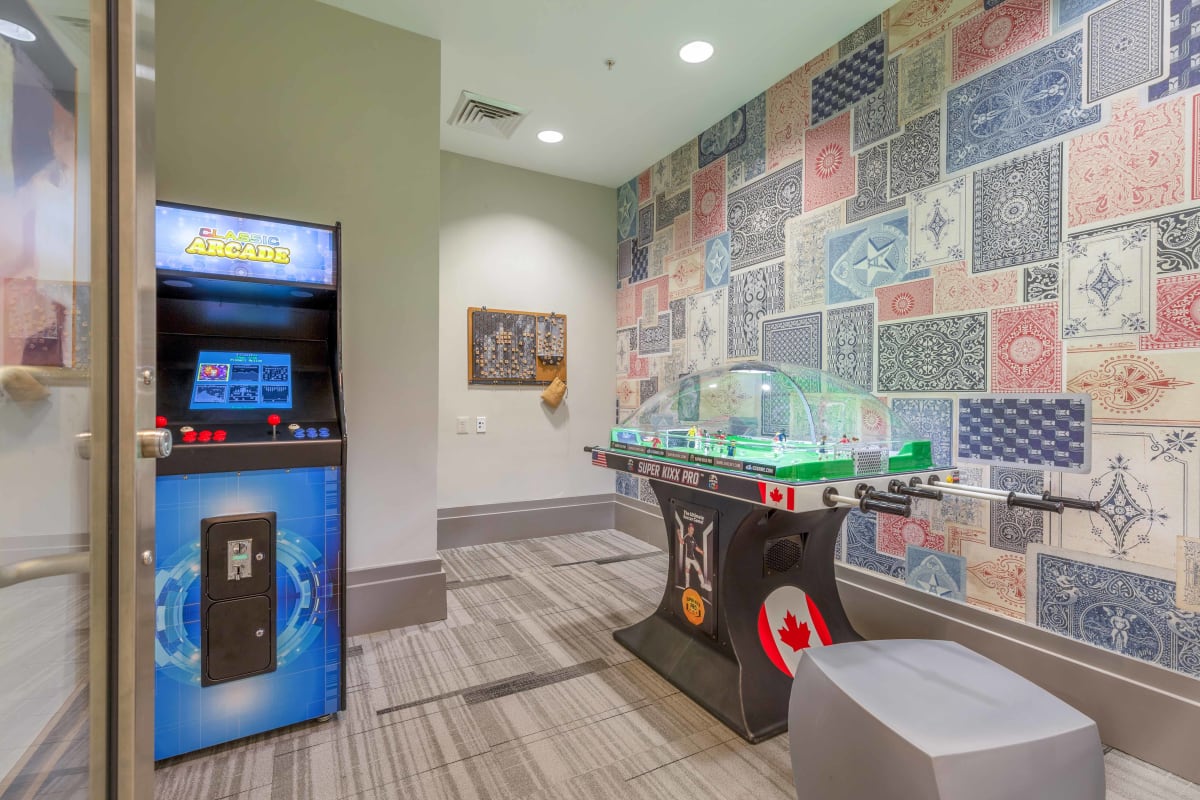 The Alaire Twinbrook Station Apartments game room with arcade games - Rockville, MD
