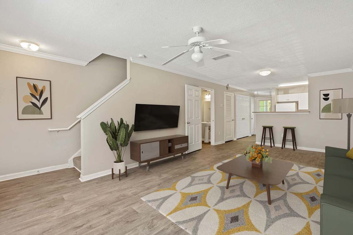 Alexander Crossing Apartments & Townhomes living room with stairs - Loganville, GA