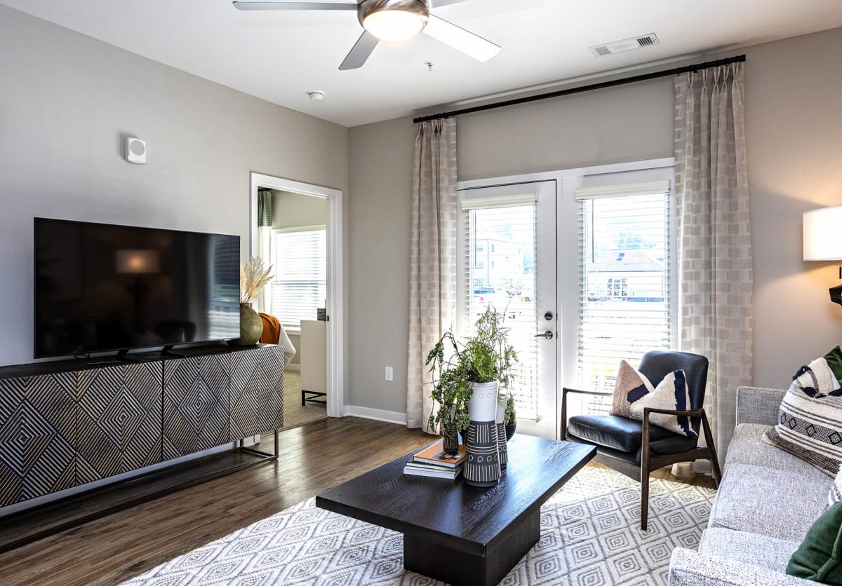 Vintage Cleveland Apartments living room with sliding doors and TV - Cleveland, TN