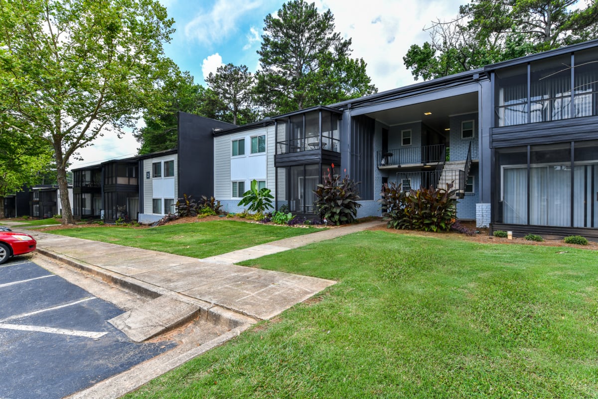 The Flats @ 1885 Apartments exterior buildings with green space - Lake City, GA