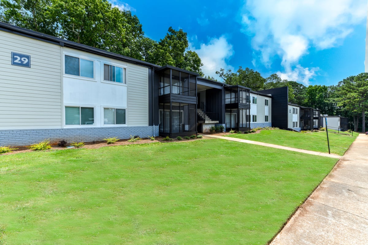 The Flats @ 1885 Apartments exterior buildings with lawn - Lake City, GA