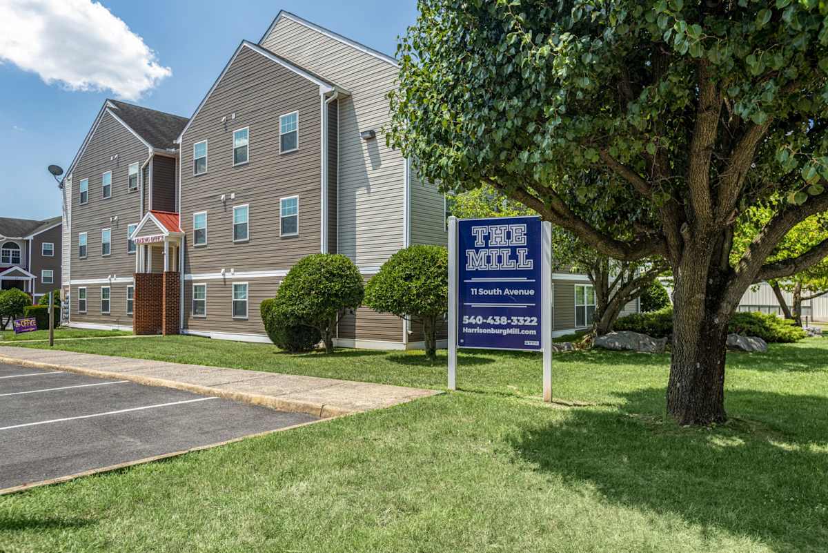 The Mill Apartments exterior view with parking lot - Harrisonburg, VA