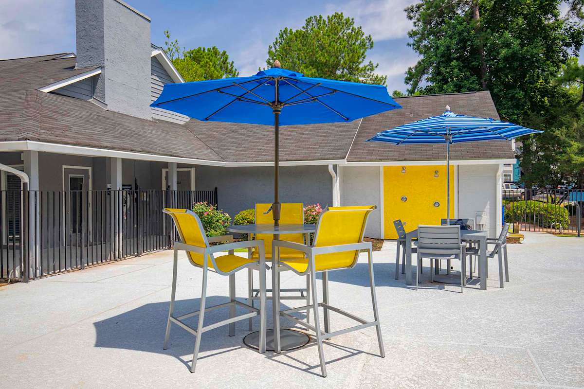 Willow Trail Apartments pool seating area with umbrella - Norcross, GA