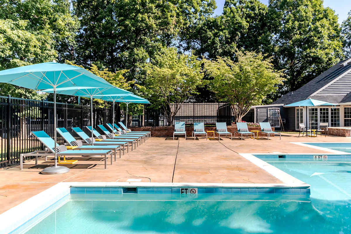 Amberton Apartments pool sundeck with umbrellas - Manassas, VA