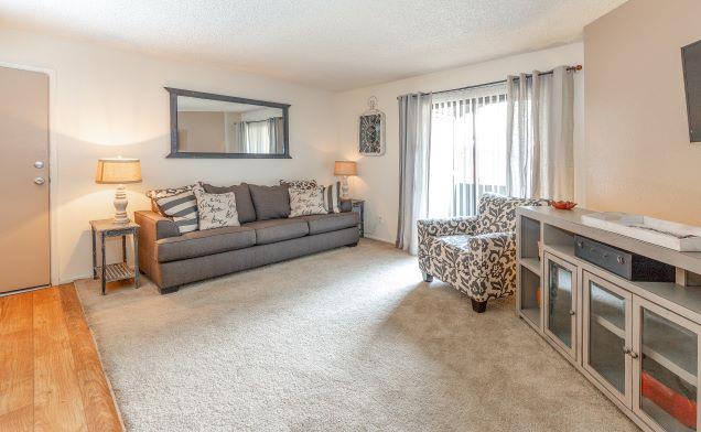 Furnished living room with patio doors — view 2 at Ranchwood Apartments.