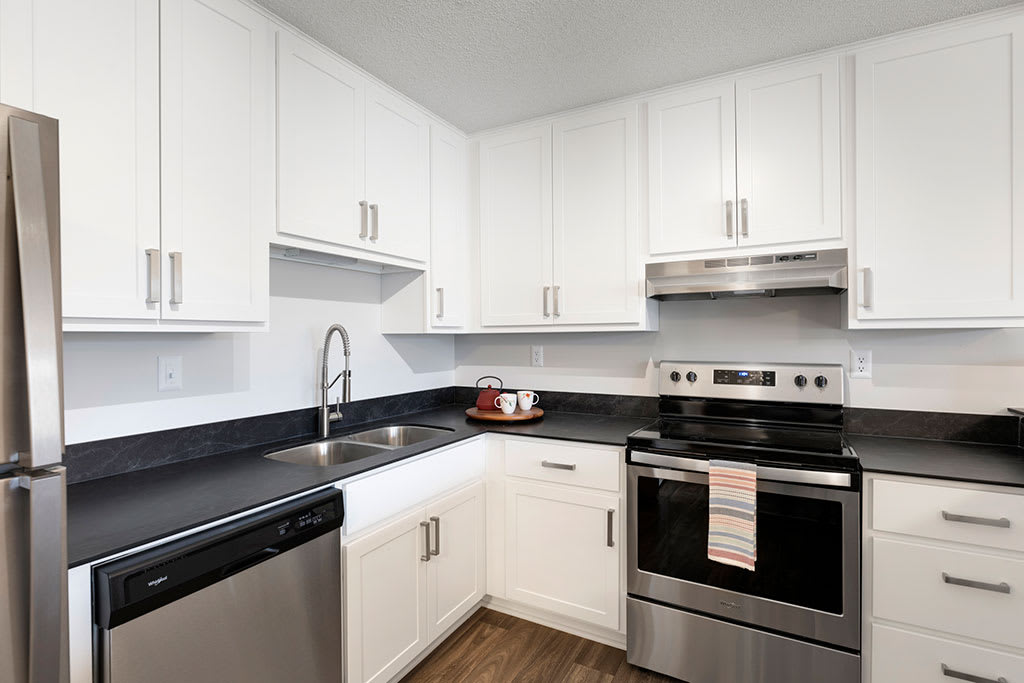 Tylia Apartments kitchen with white cabinets and stainless appliances - Maple Grove, MN