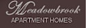 A brown sign that says Meadowbrook Apartment Homes.