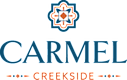 A logo with the text "CARMEL CREEKSIDE" in blue with a decorative element above the text.
