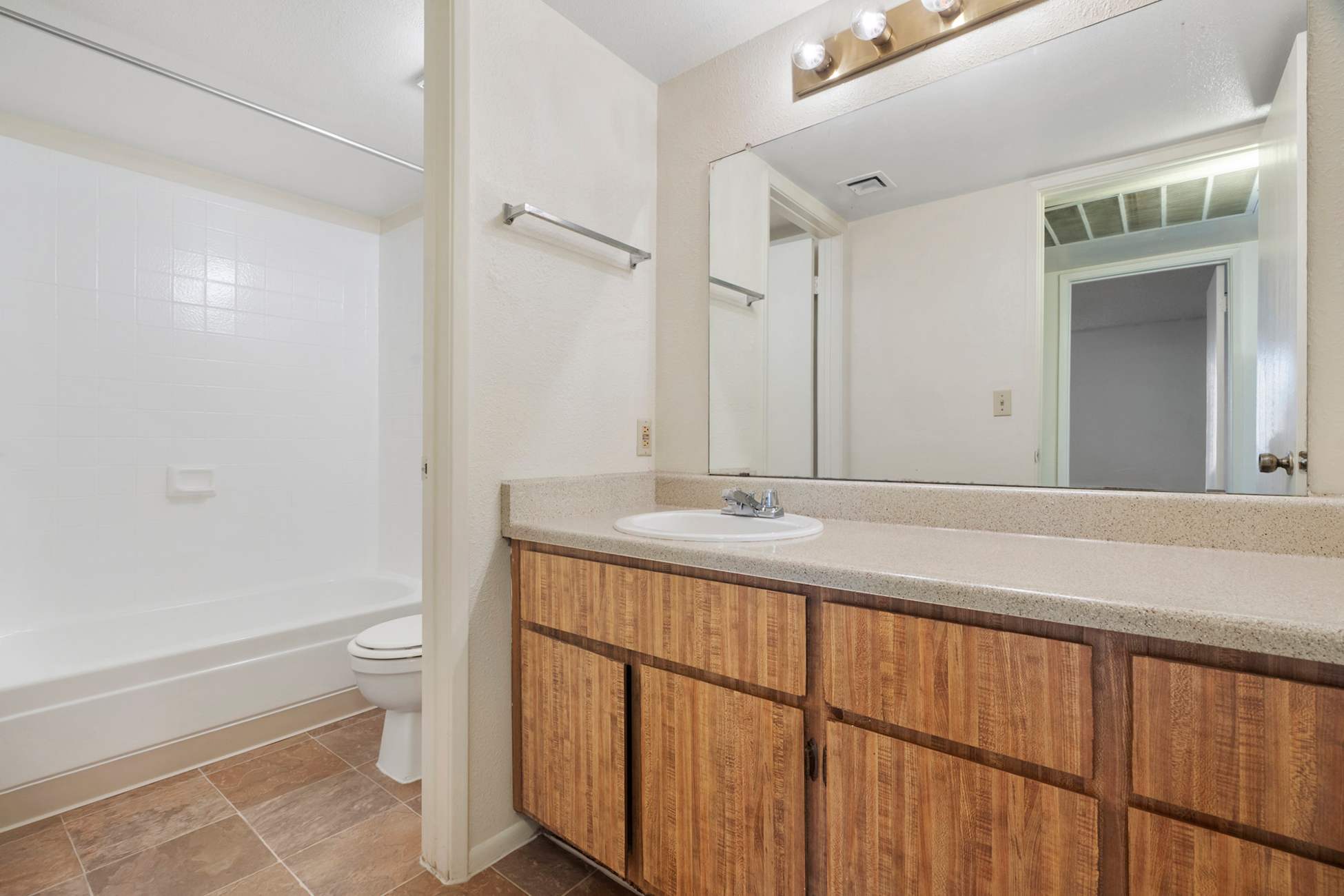 Apartment bathroom — representative home at Townhomes on the Park Apartment Homes.
