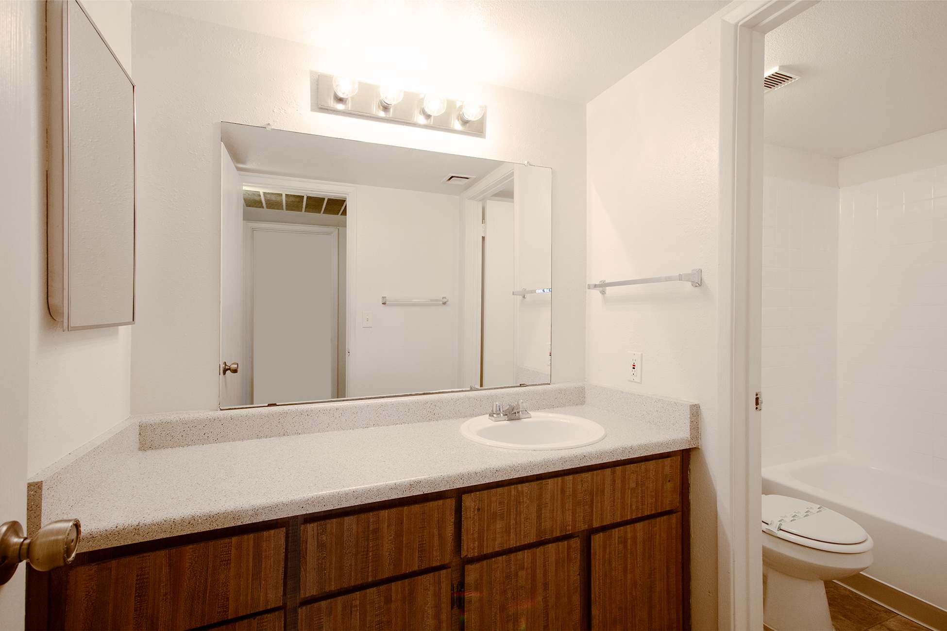 Apartment bathroom — representative home at Townhomes on the Park Apartment Homes.