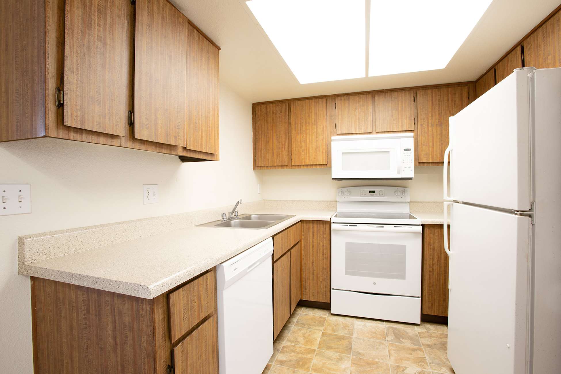 Apartment kitchen — representative home at Townhomes on the Park Apartment Homes.