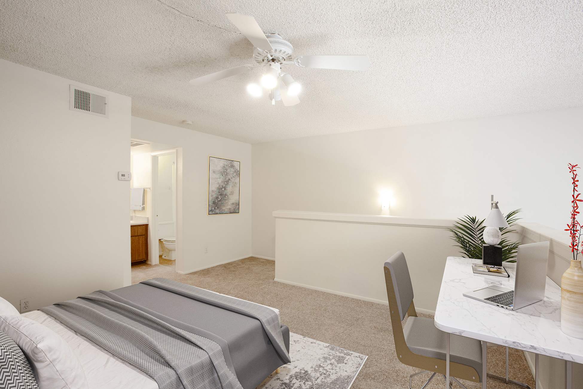 Furnished bedroom shown — representative home at Townhomes on the Park Apartment Homes.